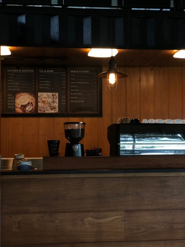Dark brown rustic coffee shop interior with wooden tables and warm lighting