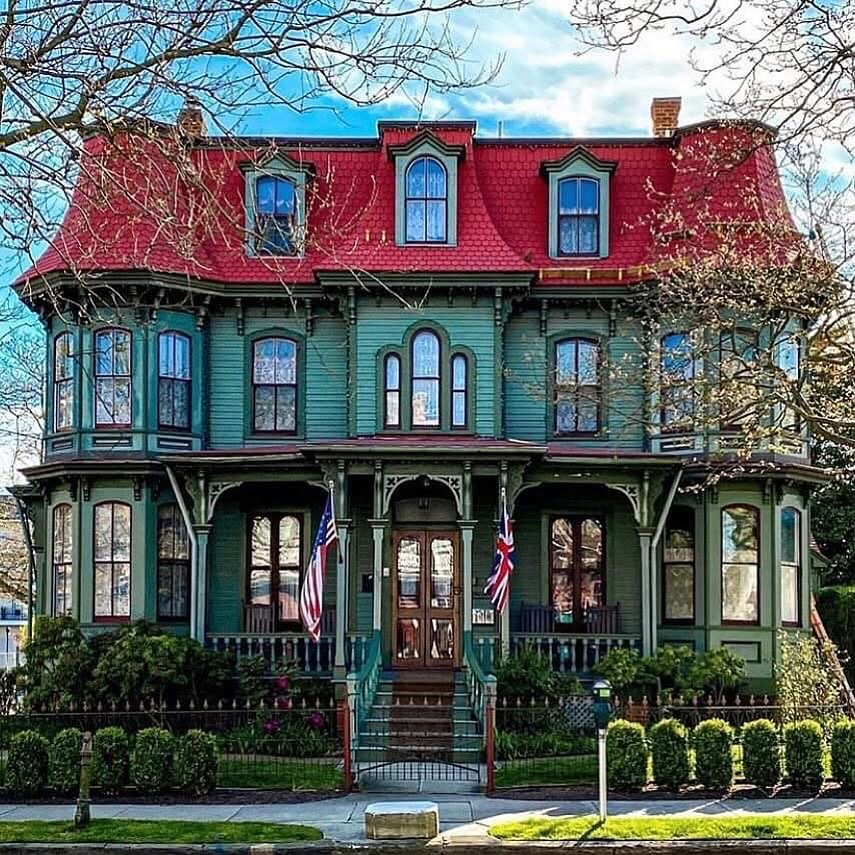 Victorian house with red roof and green walls in Cape May