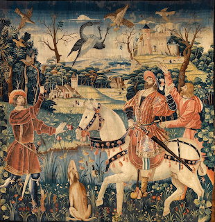 Medieval tapestry with riders, a hunter, dogs, and birds in a pastoral landscape