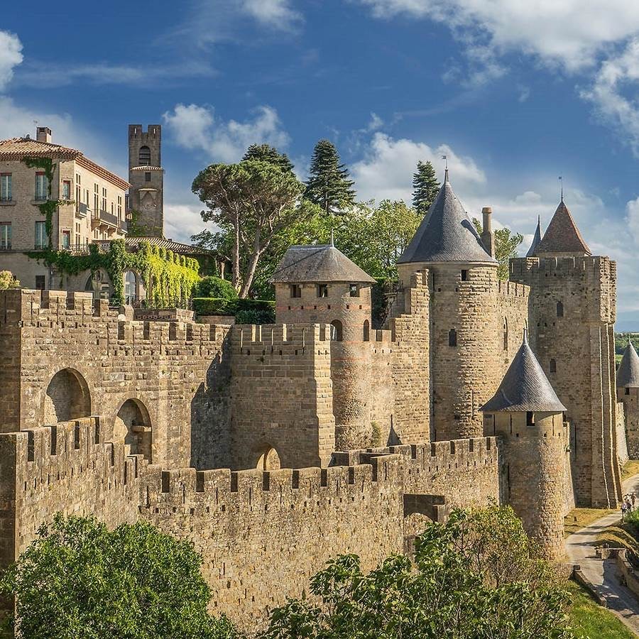 Medieval stone fortress with towers and walls in Carcassonne, France under blue sky