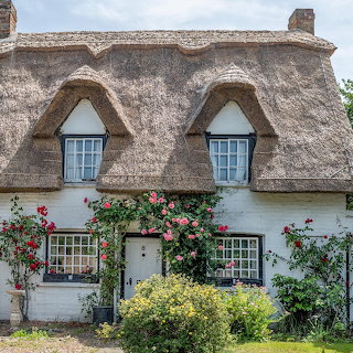 Thatched Roof Cottage with Roses