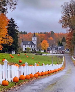 New England village road with white picket fence, pumpkins, white church, and colorful autumn foliage