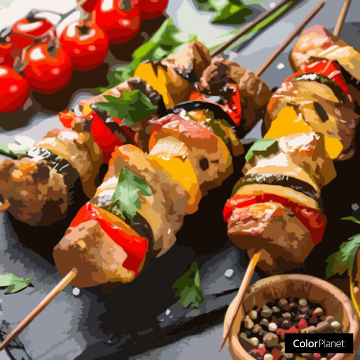 Grilled meat and vegetable skewers with cherry tomatoes and peppercorns on a dark table