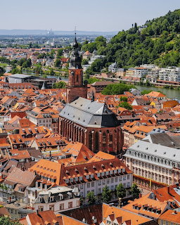 Aerial view of Heidelberg old town with red roofs and prominent church tower surrounded by hills
