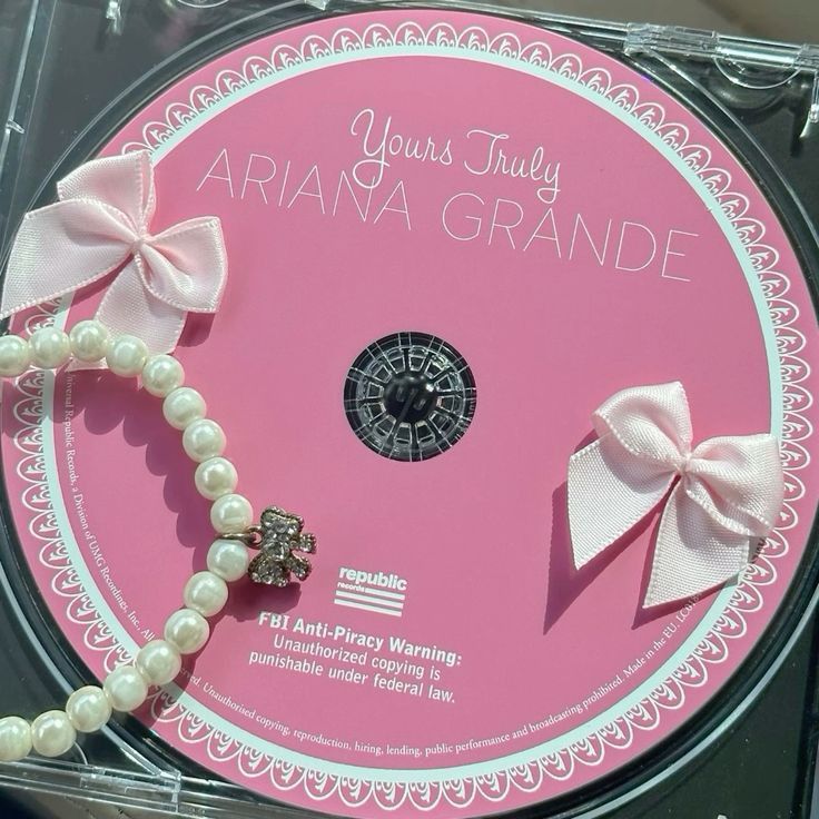 Pink Ariana Grande Yours Truly album CD with lace border, pink bows, and pearl necklace decoration