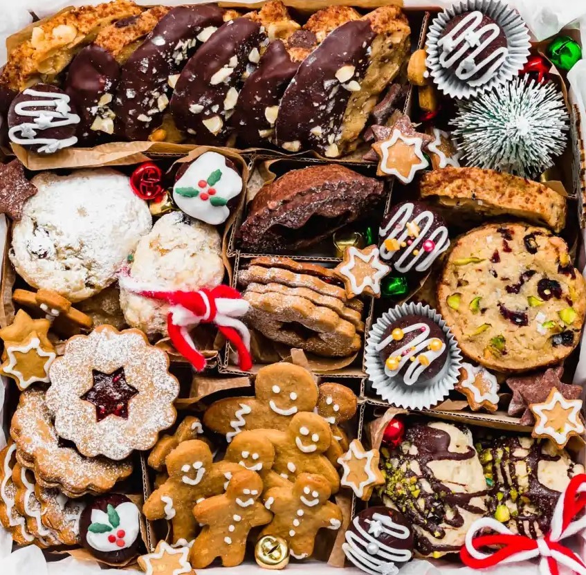 Assorted Christmas cookies and treats with gingerbread men, candy canes, and festive decorations