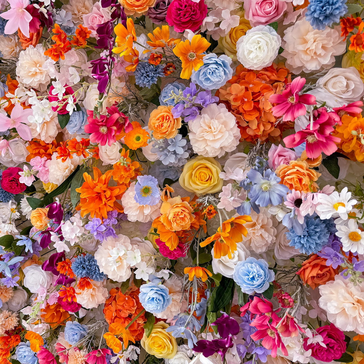 Overhead view of densely packed colorful flowers in various types and vibrant hues