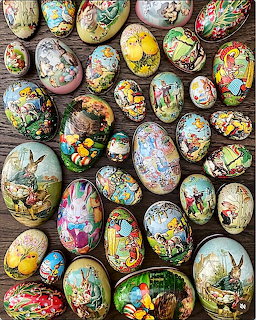 Colorful decorated Easter eggs with painted scenes arranged on rustic wood