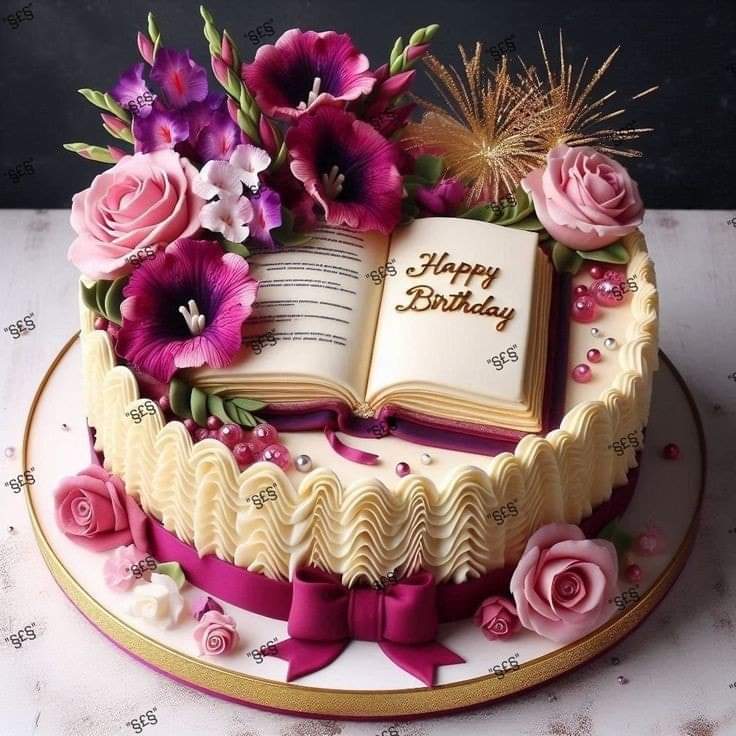 Birthday cake with pink and purple flowers, open book topper, and sparkler candles