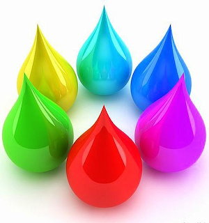 Seven colorful glossy 3D water droplets in rainbow colors arranged on a white surface